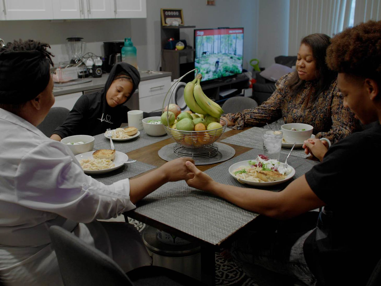 An image of a family eating dinner together at a dining table